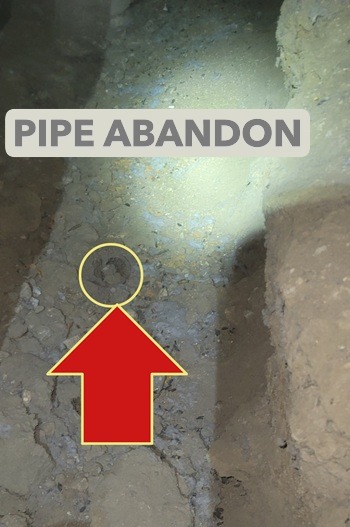 Rodent droppings and soil disruption near former sewer pipe penetration in Pasadena crawlspace